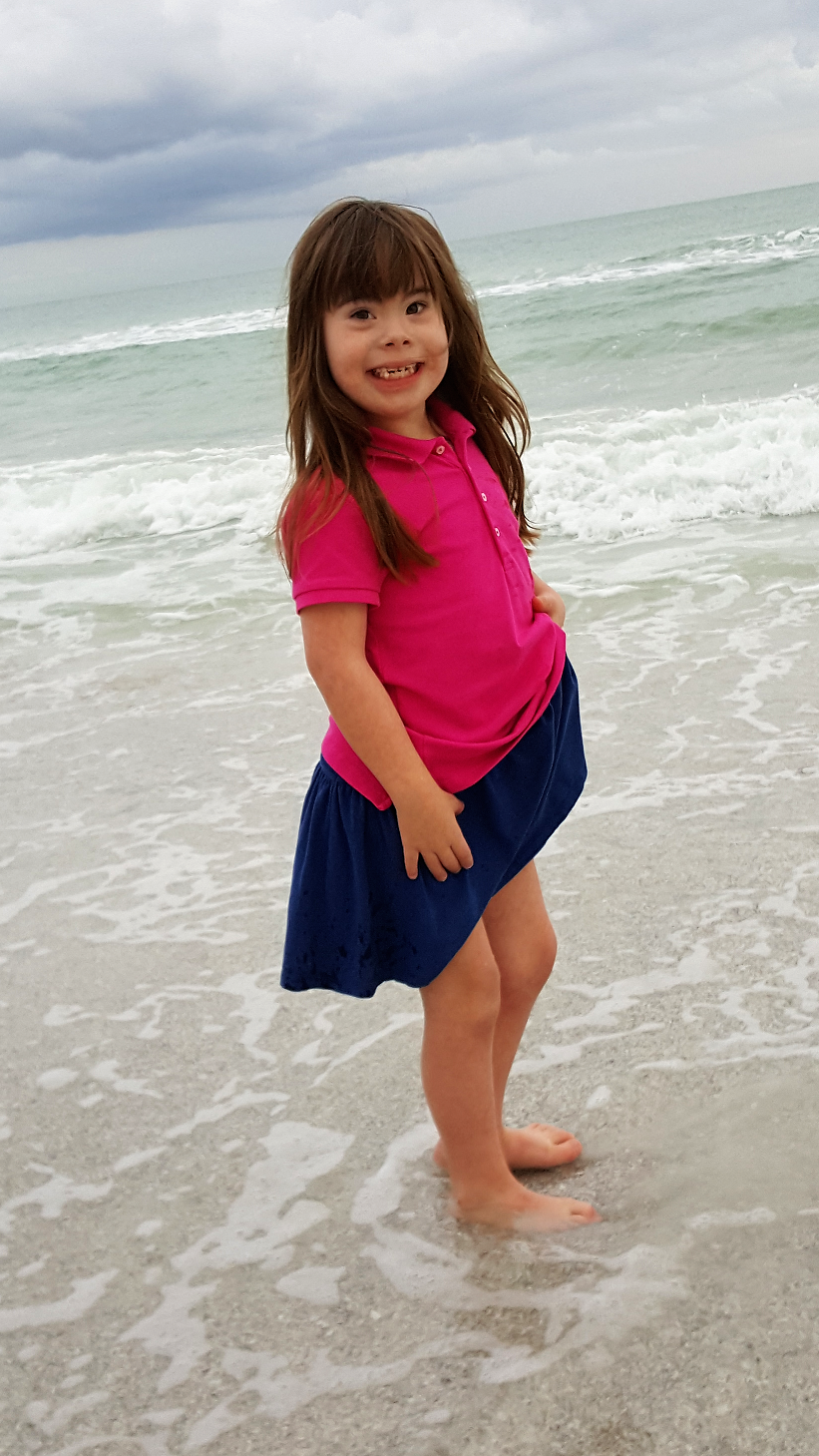 Child with Down Syndrome having fun on Beach in Florida